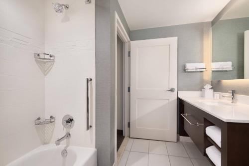 a bathroom with a tub and a toilet and a sink at Residence Inn by Marriott Spartanburg Westgate in Spartanburg