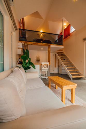 a room with white beds and a staircase at Latte Villas in Sapanca