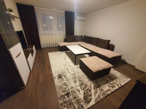 a living room with a couch and a table at IRIS Apartments in Bitola
