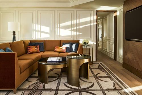 a living room with a couch and a tv at The Ritz-Carlton, Denver in Denver