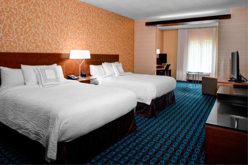 a hotel room with two beds and a television at Fairfield Inn & Suites by Marriott Douglas in Douglas