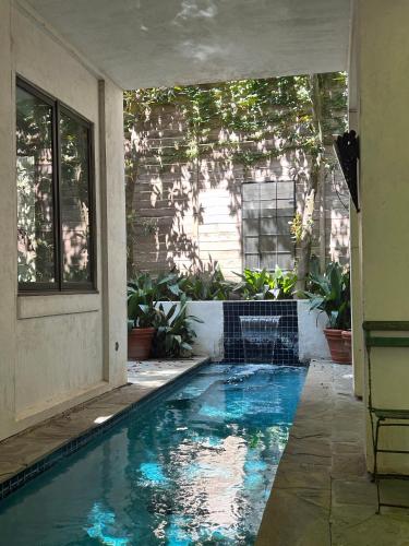 a swimming pool in the middle of a house at Elegant French Patio Home with Private Pool in Houston