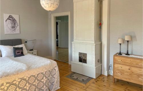 a bedroom with a bed and a fireplace at Gorgeous Home In Lindesberg in Lindesberg