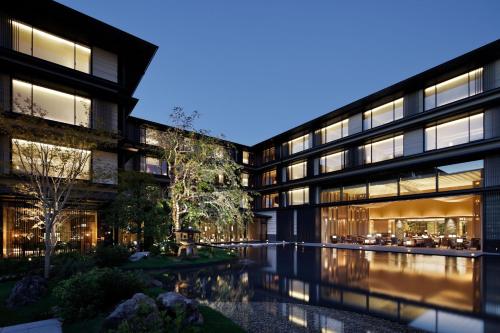an office building with a pool in front of it at HOTEL THE MITSUI KYOTO, a Luxury Collection Hotel & Spa in Kyoto
