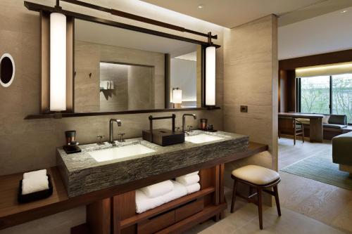 a bathroom with a large sink and a mirror at HOTEL THE MITSUI KYOTO, a Luxury Collection Hotel & Spa in Kyoto