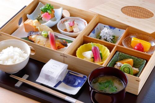a wooden box filled with different types of food at HOTEL THE MITSUI KYOTO, a Luxury Collection Hotel & Spa in Kyoto