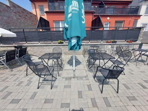 a table and chairs with an umbrella on a patio at Penzion Strachotín in Strachotín