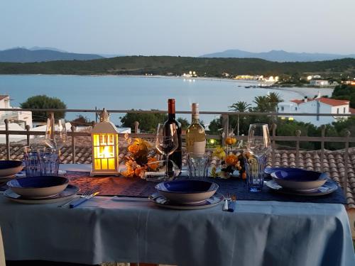 una mesa con botellas de vino y copas. en ROSA DEI VENTI - CASA MAESTRALE - Sardegna - IUN R2217, en Olbia