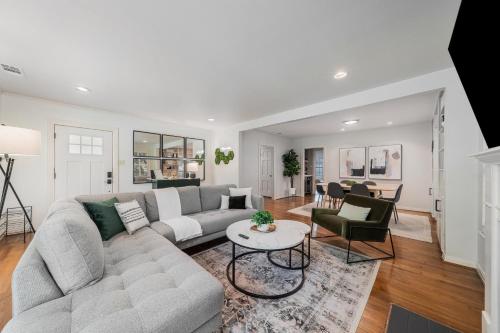 a living room with a couch and a table at Sunset House - Luxury Pool and Hot Tub Retreat in Dallas