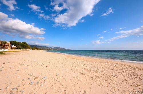 a sandy beach with the ocean in the background at La Casa Sulla Spiaggia in Flumini di Quartu