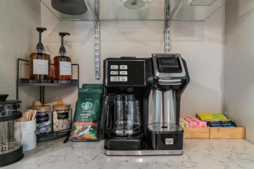 a coffee maker sitting on top of a counter at Sunset House - Luxury Pool and Hot Tub Retreat in Dallas