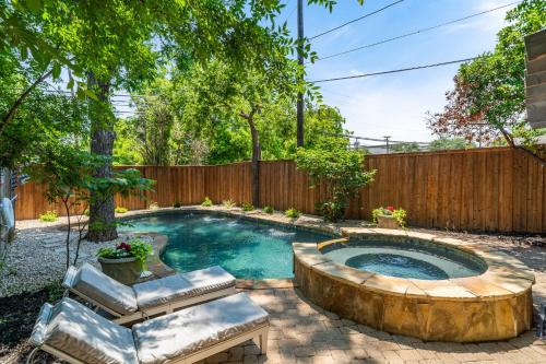 a pool in a backyard with a wooden fence at Sunset House - Luxury Pool and Hot Tub Retreat in Dallas