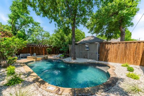 a small pool in a yard with a wooden fence at Sunset House - Luxury Pool and Hot Tub Retreat in Dallas