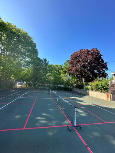 a tennis court with a net on top of it at Aspinquid Resort in Ogunquit
