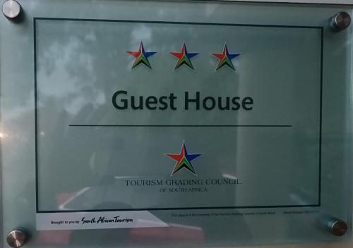 a sign for a guest house with four stars at LALA POA GUEST HOUSE in Klerksdorp