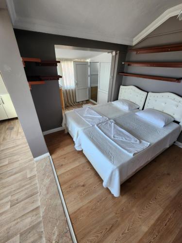 a large bed in a room with a mirror at KALMUK SUIT in Trabzon