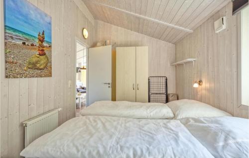 a bedroom with two beds and a painting on the wall at Freibeuterweg 20 - Dorf 5 in Travemünde