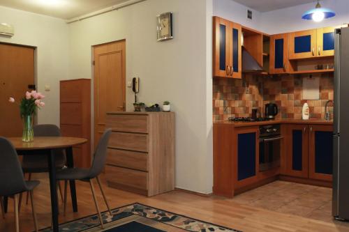 a kitchen with a table and a dining room at Mieszkanie Warszawa 3 in Warsaw