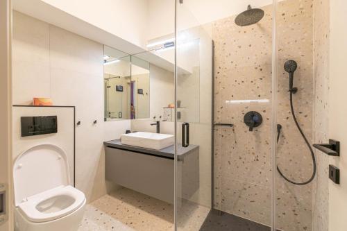 a bathroom with a shower and a toilet and a sink at Polai Park Apartments in Pula