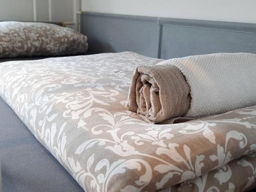 a bed with a towel on top of it at Apartment Loyd, Tolmin - Most na Soči in Most na Soči