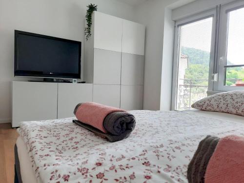 a bedroom with a bed with a towel on it at Apartment Loyd, Tolmin - Most na Soči in Most na Soči