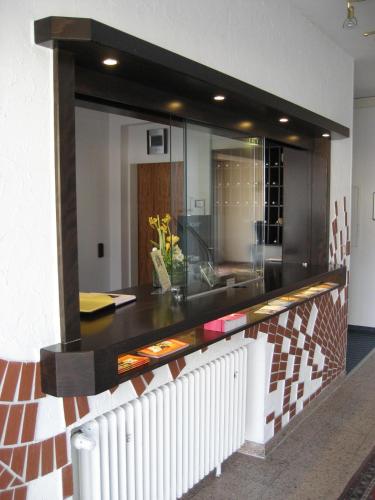 a kitchen with a counter with a glass wall at Hotel Bürger in Siegen