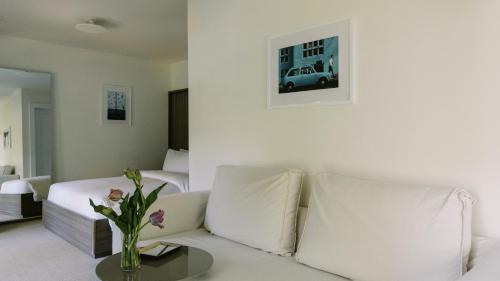 a white living room with a couch and a table at The Roundtree, Amagansett in Amagansett