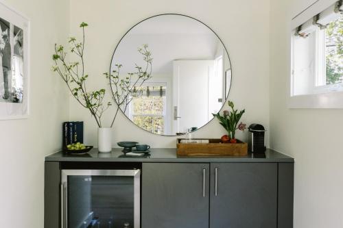 a mirror on top of a dresser in a room at The Roundtree, Amagansett in Amagansett