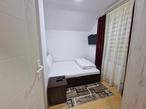 a small room with a bed and a door at Vila Vlasina in Vlasina Rid