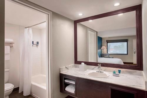 a bathroom with a sink and a mirror at Four Points by Sheraton Anaheim in Anaheim