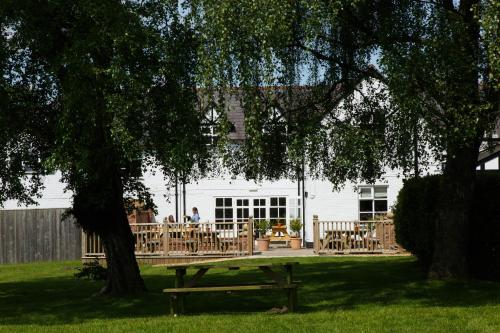 a picnic table under a tree in front of a house at The Egerton Arms in Chester