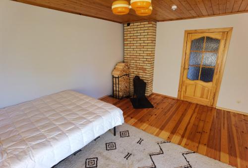 1 dormitorio con 1 cama y suelo de madera en Kemeri Roomstay & Sauna, en Jūrmala