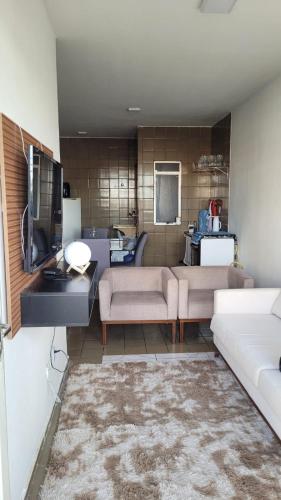 a living room with two couches and a tv at Apartamento completo para São João in Campina Grande