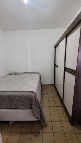 a white room with a bed and a closet at Apartamento completo para São João in Campina Grande