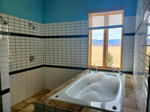 a bath tub in a bathroom with a window at Dream Drift Motel in Cameron