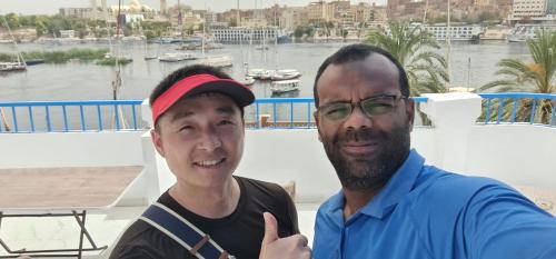 two men posing for a picture on a boat at La Terrace in Aswan