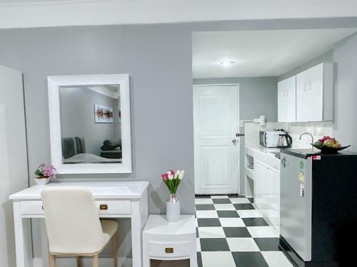 a kitchen with a black and white checkered floor at Sea sand sun Condominiums in Rayong