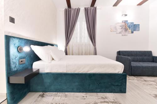 a bedroom with a bed and a couch and a chair at Luxury Rooms "Kaleta" in Trogir