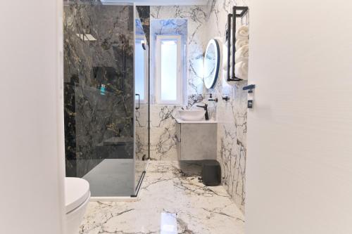 a bathroom with a shower and a sink and a toilet at Luxury Rooms "Kaleta" in Trogir