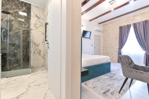 a guest room with a king sized bed and a window at Luxury Rooms "Kaleta" in Trogir