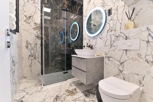 a bathroom with a shower and a toilet and a sink at Luxury Rooms "Kaleta" in Trogir