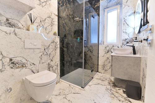 a bathroom with a toilet and a shower and a sink at Luxury Rooms "Kaleta" in Trogir