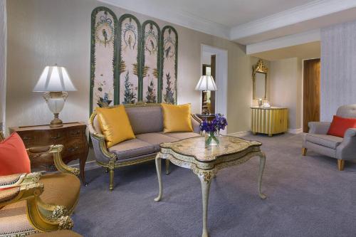 a living room with a couch and a table at Sheraton Towers Singapore Hotel in Singapore