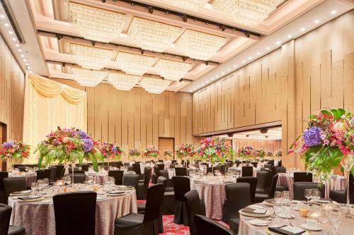 a banquet hall with tables and chairs and flowers at Sheraton Towers Singapore Hotel in Singapore