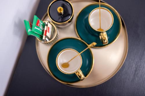 a plate with two green plates on a table at Luxury Rooms "Kaleta" in Trogir