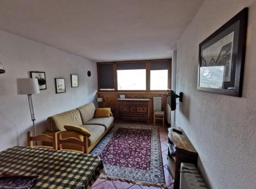 a living room with a couch and a bed at Val di Sole Holidays in Folgarida