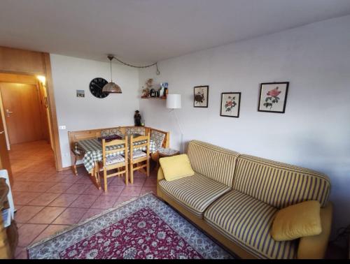 a living room with a couch and a table at Val di Sole Holidays in Folgarida