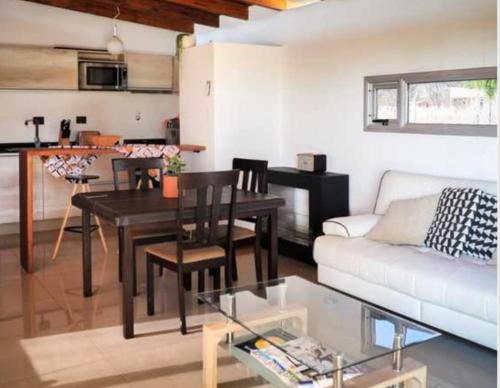 a living room with a table and a couch at Cabaña La Ilusión in Villa Ciudad Parque