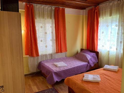 a small bedroom with two beds and a window at Constantinescu A in Buşteni