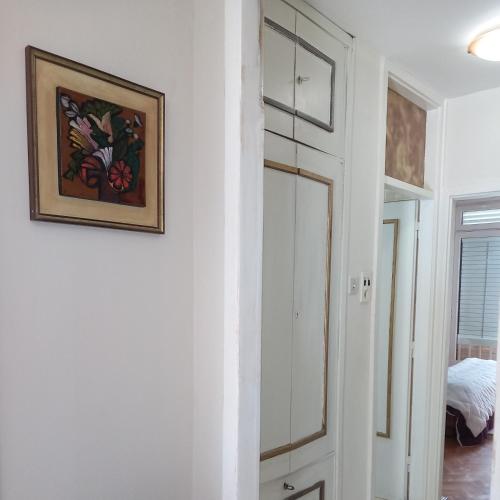 a hallway with a mirror and a painting on a wall at Apartment Navigator's lodging in Kotor